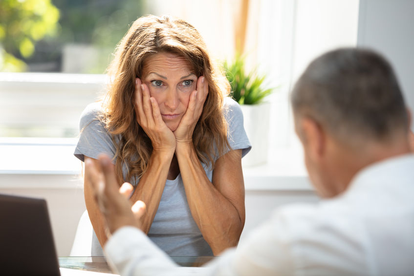 Sad Woman Looking At Her Colleague